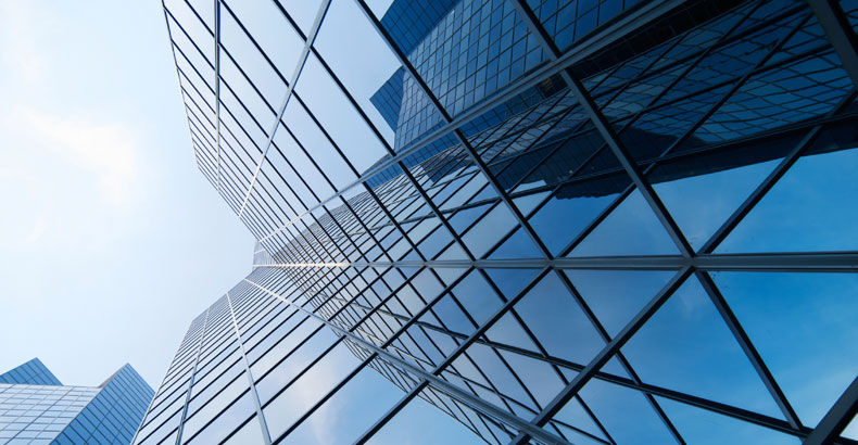 Glass office towers seen from street level