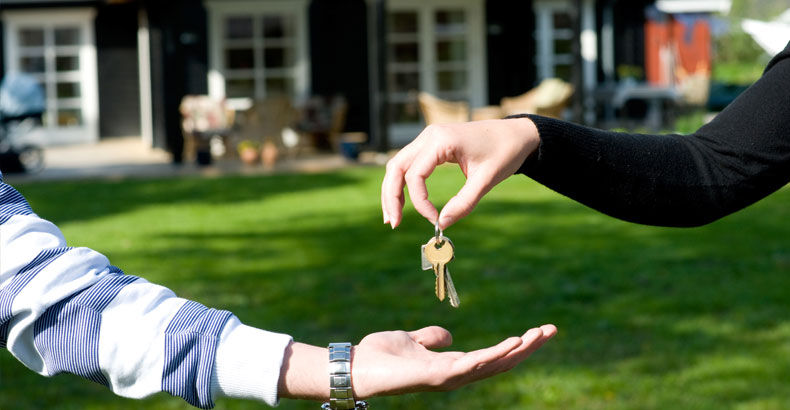 An agent handing over house keys
